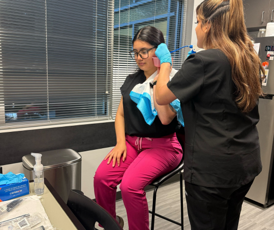 Medical Assistant School Student performing an ear exam